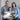 Family holding personalized pier sign wall art with custom names on wooden signpost over ocean scene